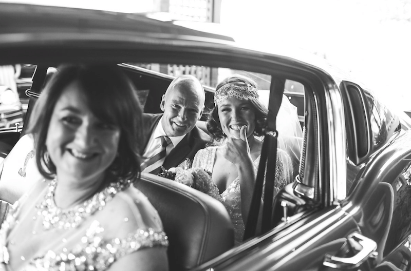 bride in vintage car before ceremony