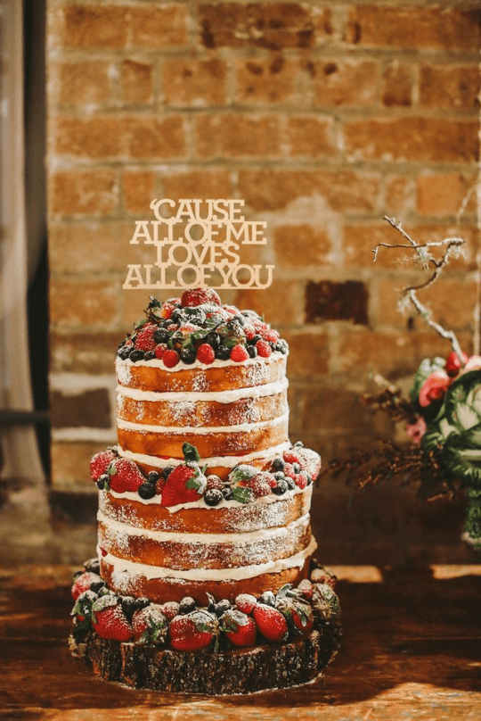 naked wedding cake and quote cake topper