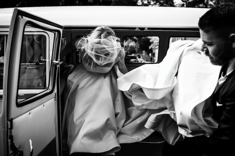 bride exiting vintage vw bus