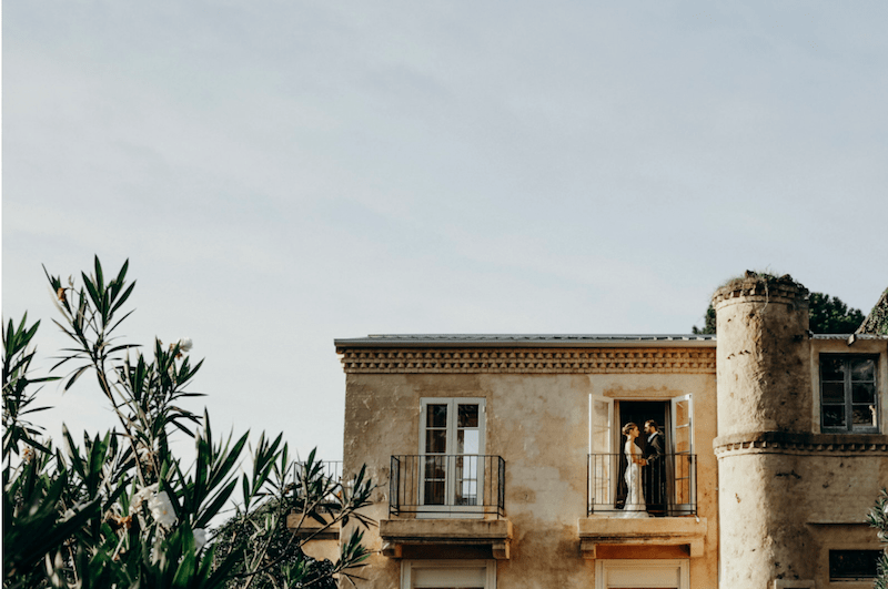 French Estate Formal Wedding bride and groom on balcony