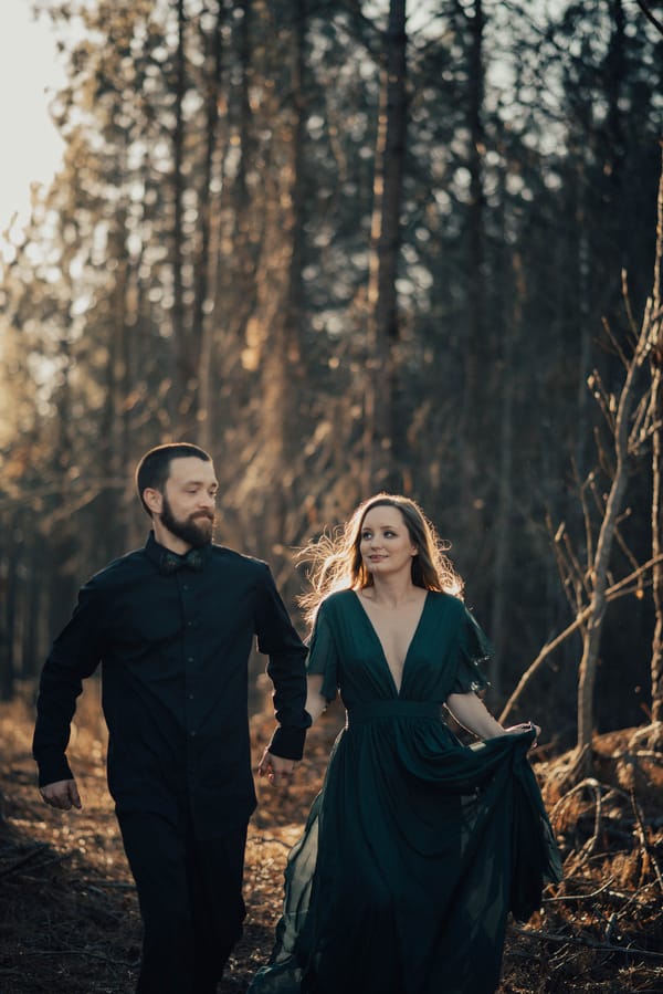 Jane-Eyre-Inspired-Anniversary-Shoot-bride-and-groom-walking-forest