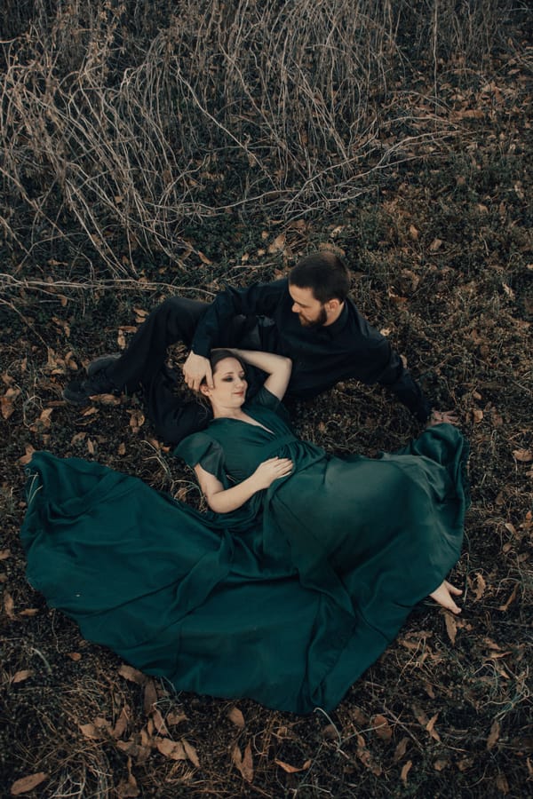 Jane-Eyre-Inspired-Anniversary-Shoot-bride-laying-in-field