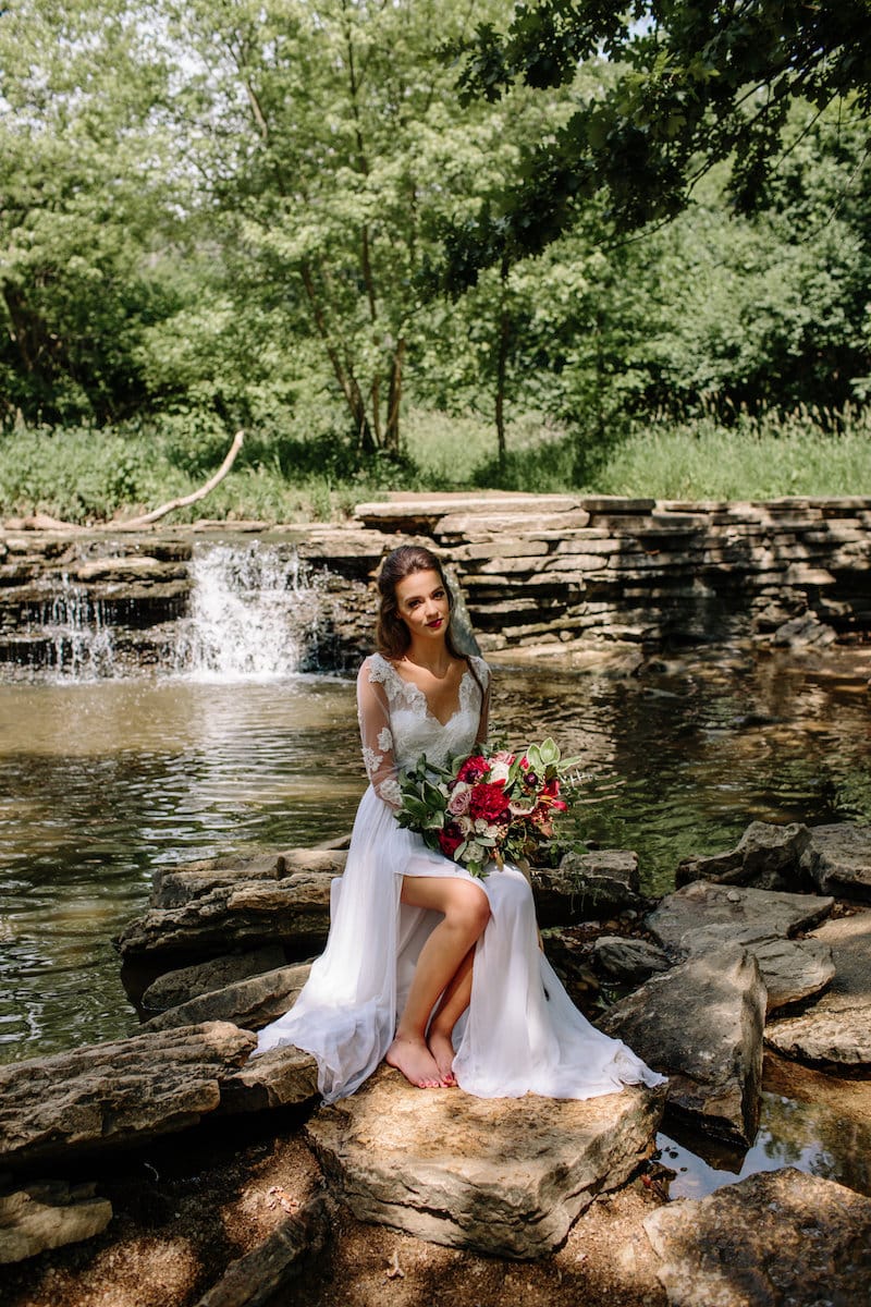 vintage forest styled shoot bride on bed rocks