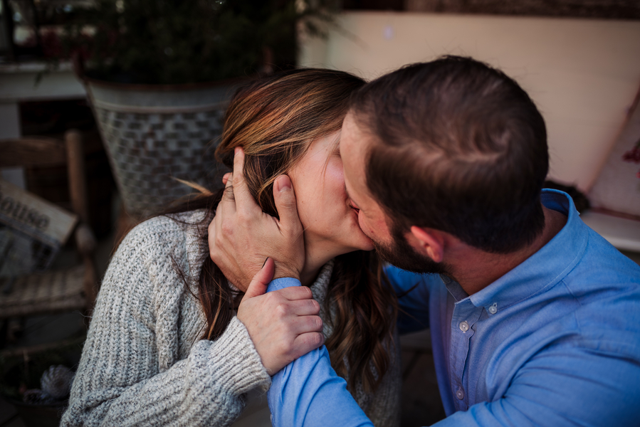 Vintage-village-christmas-themed-engagement-kiss