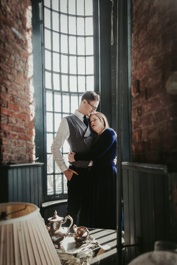 moody-antique-store-engagement-shoot-couple-hug