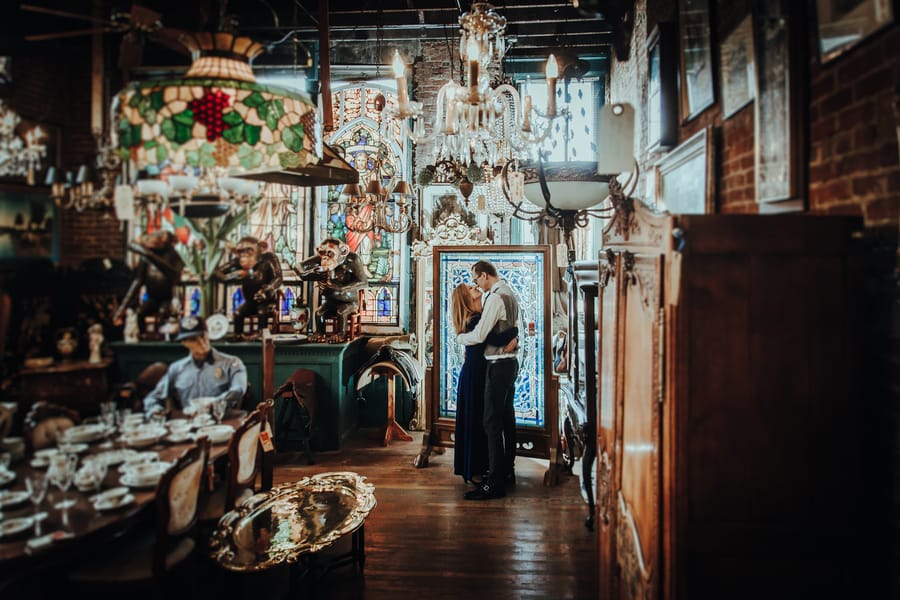 moody-antique-store-engagement-shoot-couple-kiss