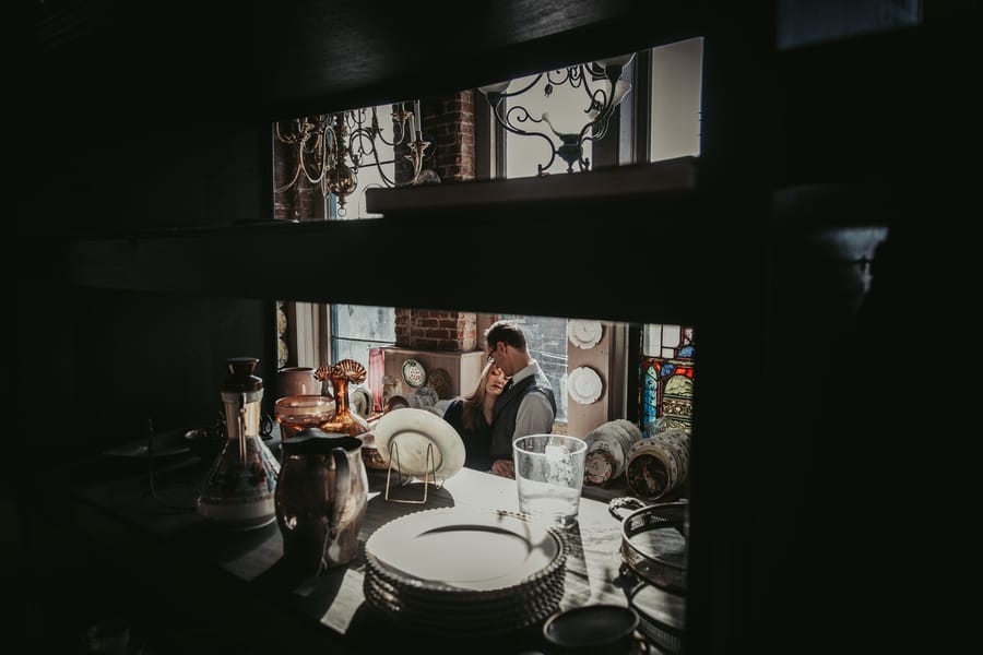 moody-antique-store-engagement-shoot-couple-vintage-china