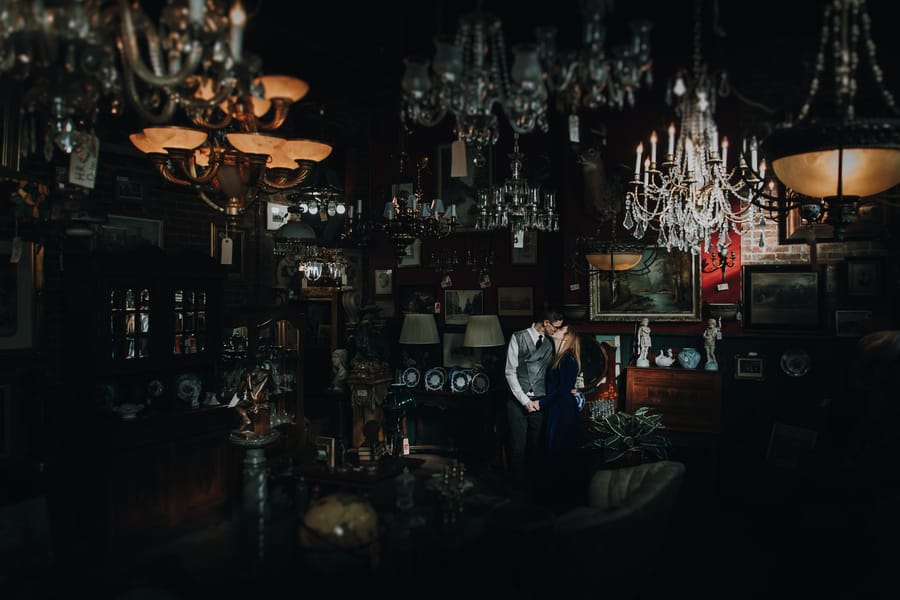 moody-antique-store-engagement-shoot-vintage-kiss