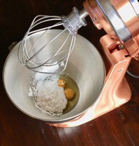 Image showing the eggs and confectioner's sugar in kitchen aid mixer